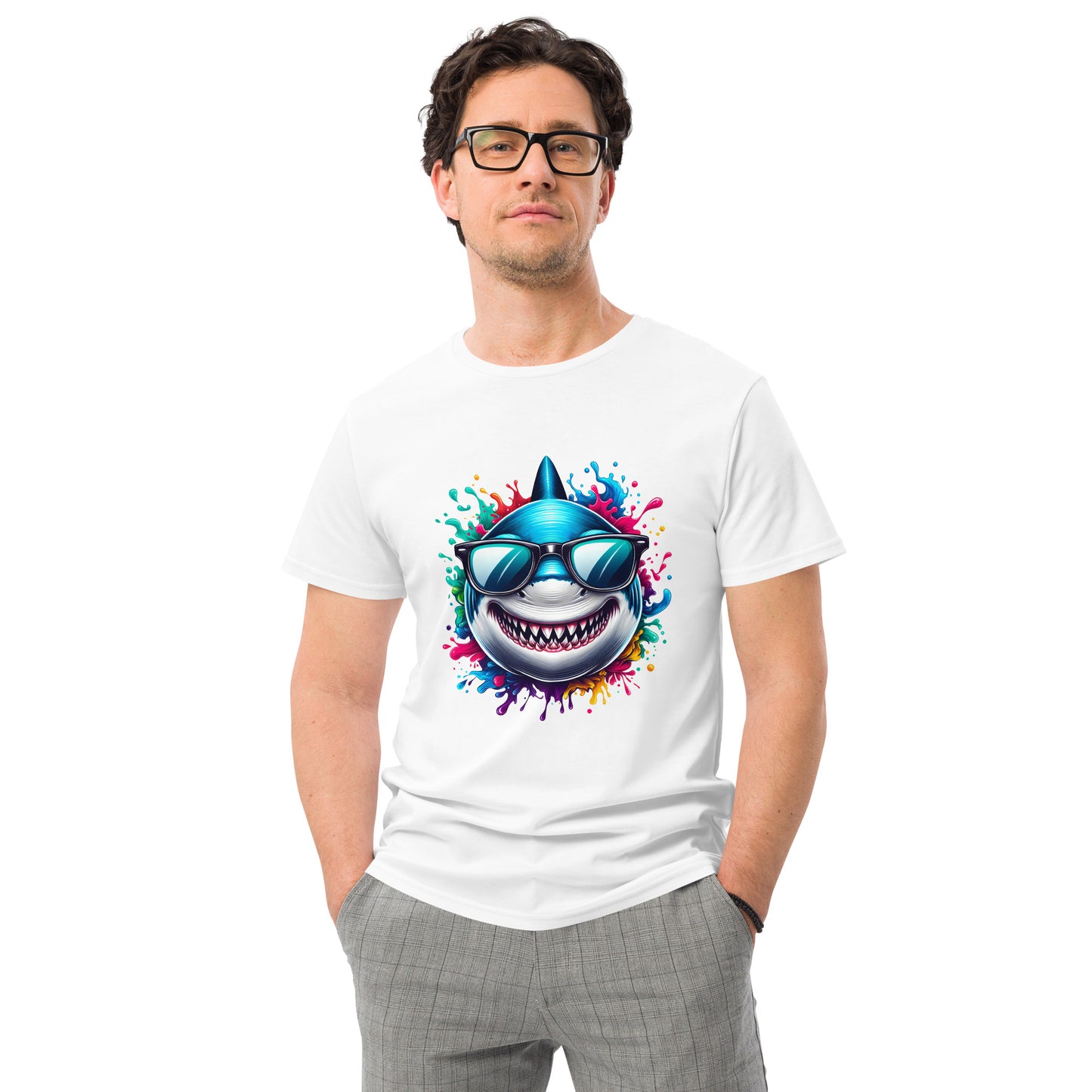 Grinning cartoon shark with sunglasses bursting through rainbow-coloured splash design on a white t-shirt.