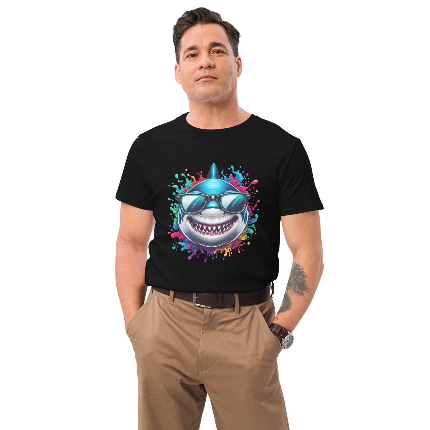 Grinning cartoon shark with sunglasses bursting through rainbow-coloured splash design on a white t-shirt.

